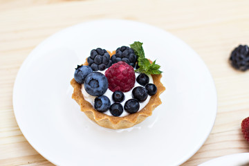 Tart  with Fresh berries - dessert on wooden table close up