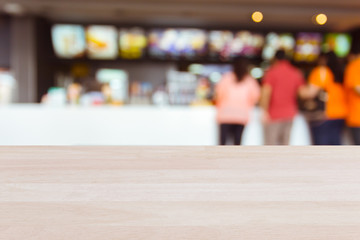 Plank wood or table top with blurred food shop background : Can use for montage or display your product.