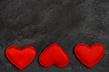 Naklejka na ściany i meble black stone background with red hearts