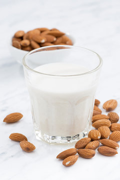 almond milk in a glass, closeup, vertical