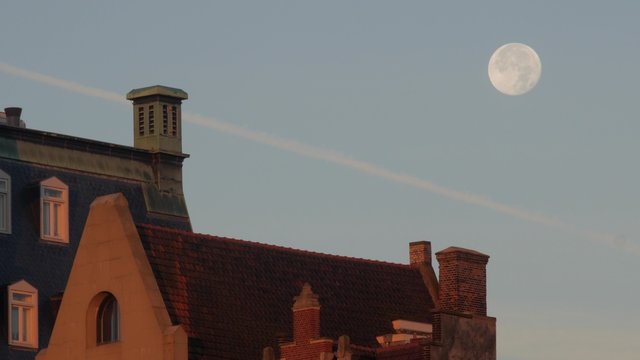 Static long shot of the gabled houses on Damtrak Amsterdam. A full moon is behind. Shot in 4K