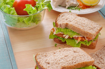 Sandwich with chicken on a wooden board