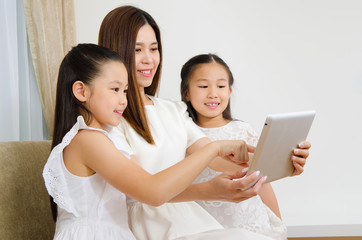 Asian family using tablet computer