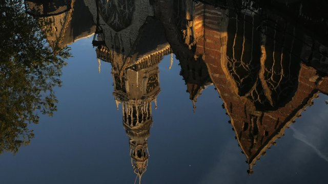 Reflections in a canal of De Oude Kerk in Amsterdam. 