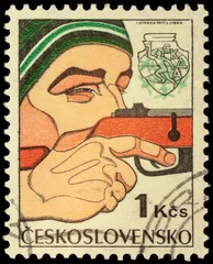 Abwaschbare Fototapete Man shooting a gun on post stamp © Vic