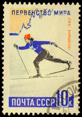 Running woman skier on post stamp
