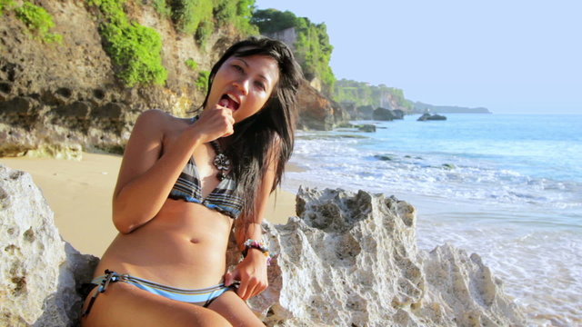 seductive sexy naughty girl lick lollipop at beach