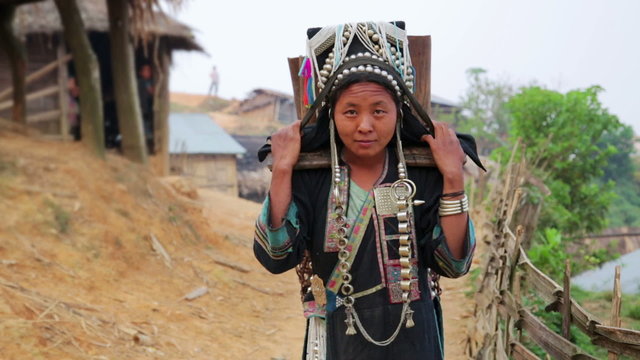 indigenous tribal native Akha woman carry water in bamboo stick