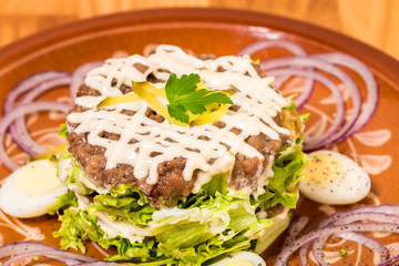 Beef steak tartare with garnish.