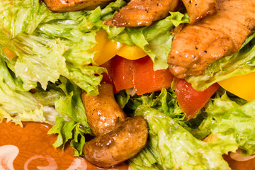 Warm pork salad with mushrooms.