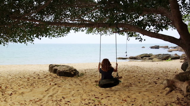 tourist girl enjoying at swing at beach, sihanoukville, cambodia