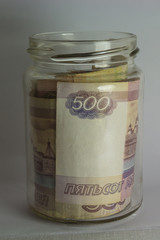 Roubles in a glass jar.