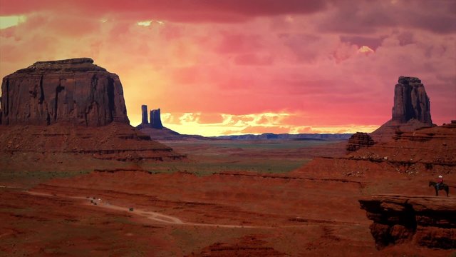 Monument Valley with Background Red Clouds in Time lapse