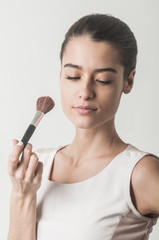 Girl holding cosmetic brush