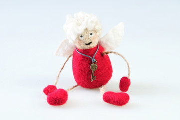 Woolen handmade toy angel on a white background . Felted wool toy. 