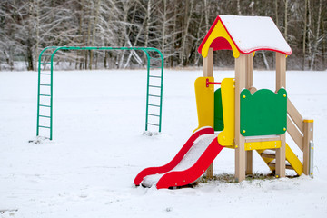 Children slider in playground in winter