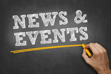 hand writes chalk text on blackboard - news and events