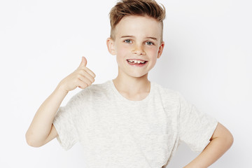 Young boy with thumbs up, portrait