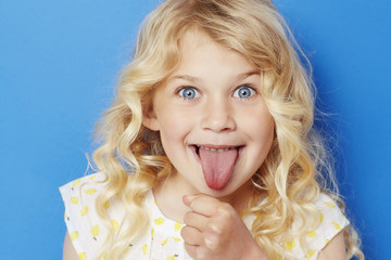 Young kid sticking out tongue, portrait