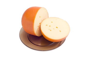 Two big pieces of cheese on a dark glass dish