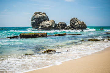 Rocks on sandy beach in Sri Lanka