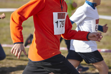Young athletics runners on a race. Outdoor circuit
