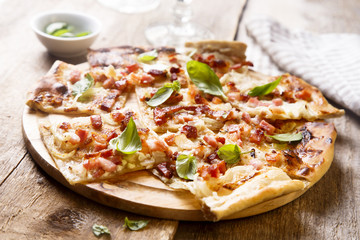 Flammkuchen pie with bacon and onion