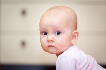 Close-up of a small child who cries but does not scream. A tear rolling down his cheek. Blurred background. Photo girl.