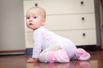small child on the floor, who was crying, but does not scream. A tear rolling down his cheek. Blurred background. Photo girl.