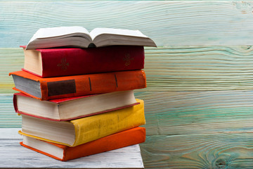 Open book, hardback books on wooden table. Back to school. Copy space