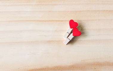 Red light wood heart-shaped and wood peg on the walls, Valentine concept , with space for textures