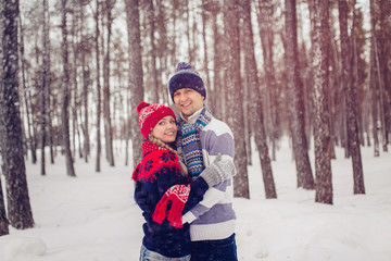 Fototapeta na wymiar winter, fashion, couple concept - smiling man and woman in hats