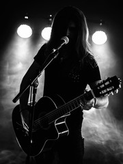 Silhouette acoustic guitar player on stage