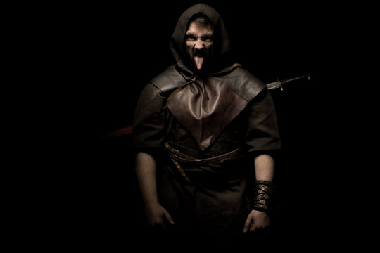 Man dressed in barbarian style with sword and moustache, bearded