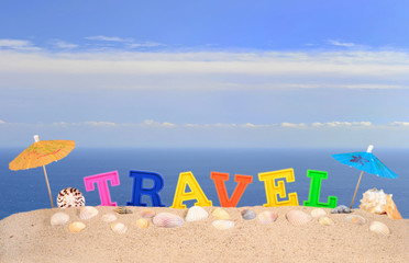 Fototapeta na wymiar Travel letters on a beach sand