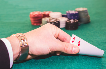 Close up of a pair of aces in a hand during a poker game - poker and lifestyle concept