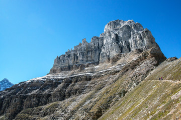 two hikers on a small trail in the Valley of the Ten Peaks in the national park of banff in the rocky mountains of alberta canada