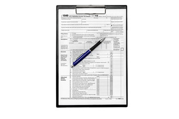 US tax form with pen on clipboard isolated on white