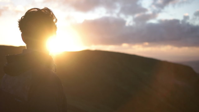 Slow motion of young caucasian man staring into the sunset on Azores Island