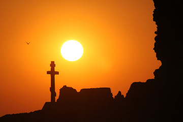 Twilight landscape with a cross monument