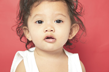 Portrait of one year old baby red background