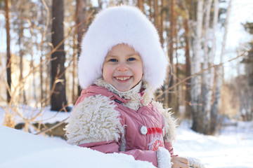 portrait of a smiling little girl in winter