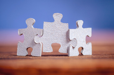 Three jigsaw puzzle pieces on a table