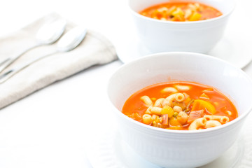 vegetable and pasta soup on a white background