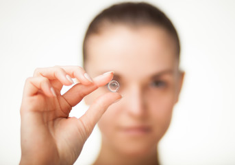 Fototapeta Woman with contact lens on finger healthcare concept obraz