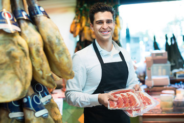 Worker selling Spanish jamon