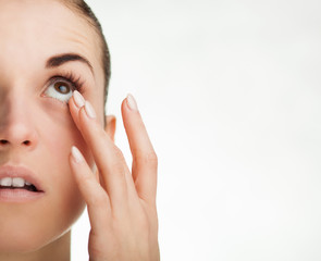 Woman touching her eye concept of healthcare
