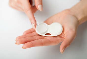 Contact lens on finger with case