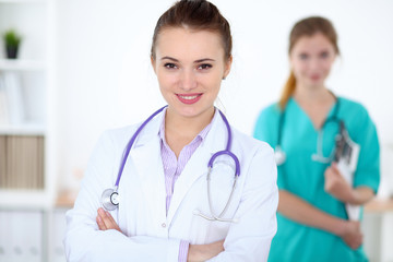 Fototapeta premium Portrait of young female doctor in a hospital