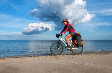 Fototapeta na wymiar woman bike riding on bank of Mediterranean Sea